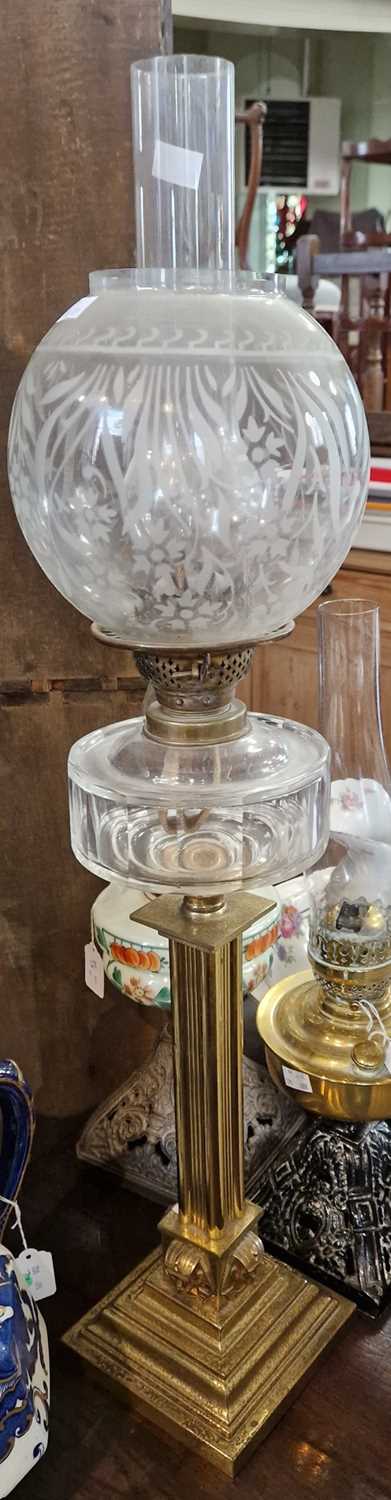 A late 19th / early 20th century brass and glass paraffin lamp, 81cm high.