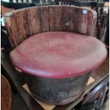 A pair of seats fashioned from whisky barrels with detachable leatherette covered seats, 42cm high.