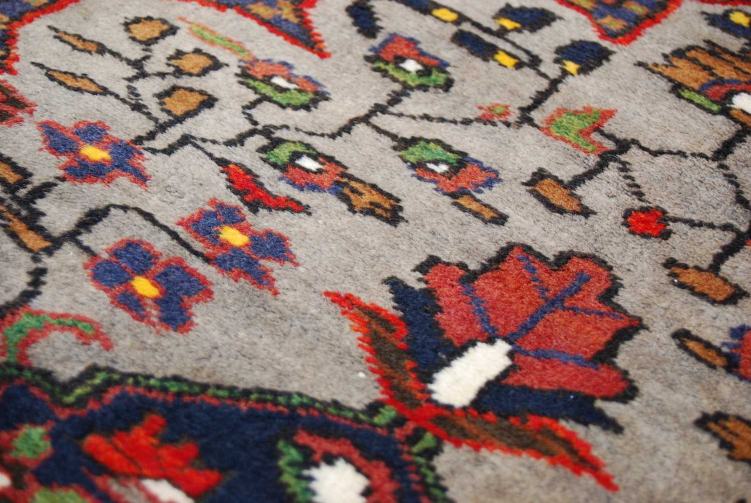 A Turkish long rug, 20th century, the rectangular abrashed madder ground centred with a large oval - Image 6 of 6