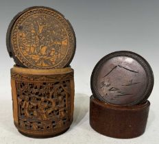 A Chinese carved bamboo cylindrical storage jar and cover, the carved panels depicting phoenix birds