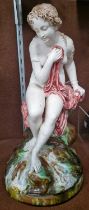 A 19th century porcelain figure group of a lady seated on a rock, 34.5cm high.