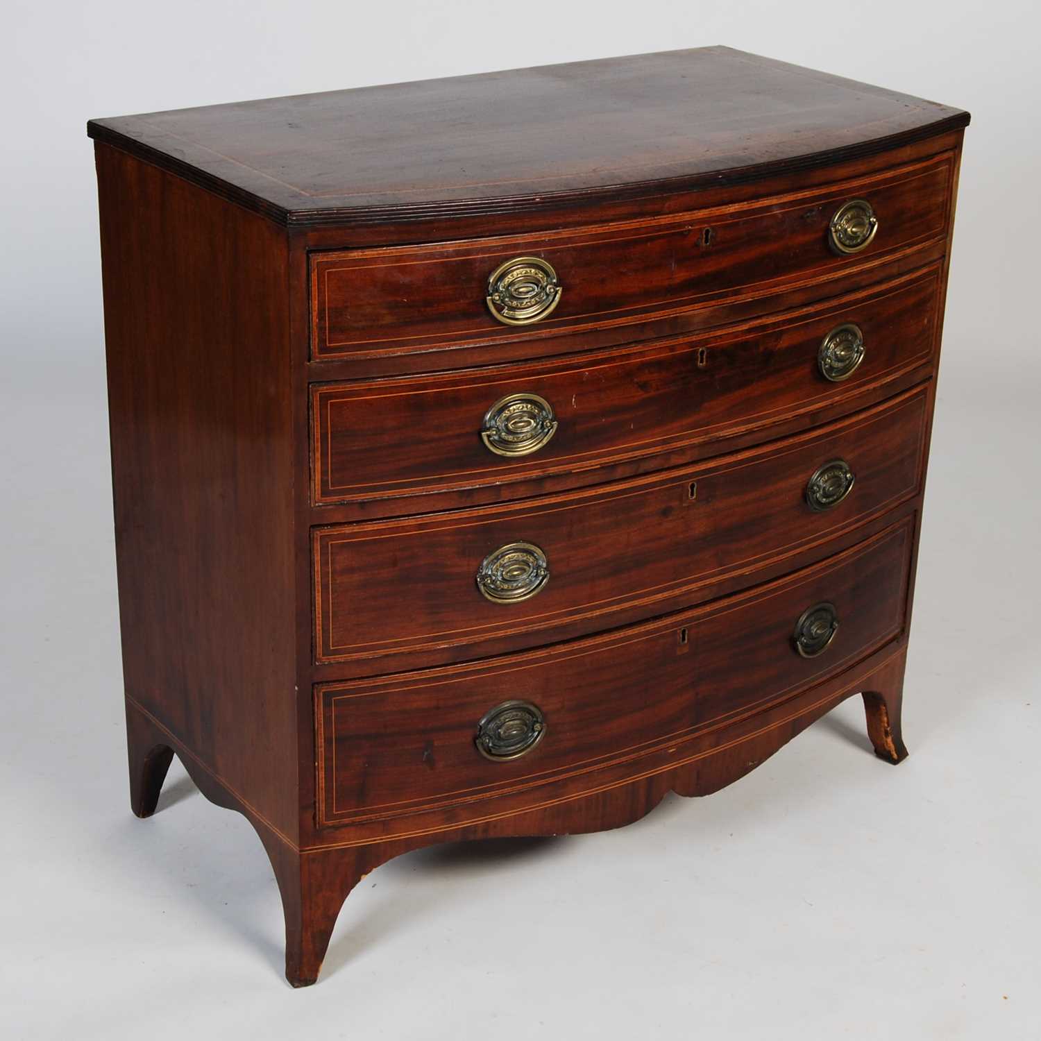 A 19th century mahogany and boxwood lined bow front chest, fitted with four long graduated