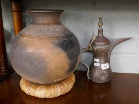East African Arab coffee pot together with an East African pot with original banana leaf stand