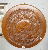 Large circular carved oak wall plaque of a dog