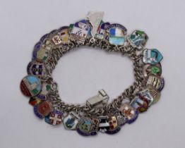 Silver and enamel charm bracelet with many charms