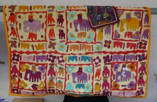 Hand embroidered throw adorned with elephants together with another