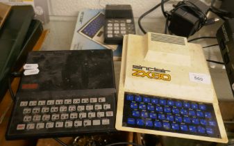 Sinclair ZX80 together with a ZX81 and programmable calculator and booklet