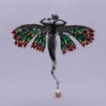 Silver and enamel winged lady pendant set with ruby