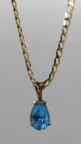 9ct gold Swiss blue topaz set pendant on 9ct gold chain with COA