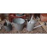 2 galvanised watering cans and a bucket