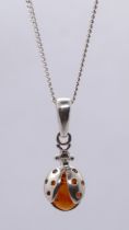 Silver and amber ladybird pendant on chain