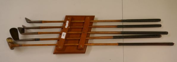 Vintage golf clubs on presentation rack