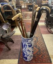 Collection of walking sticks to include hallmarked silver tipped example in blue and white stick