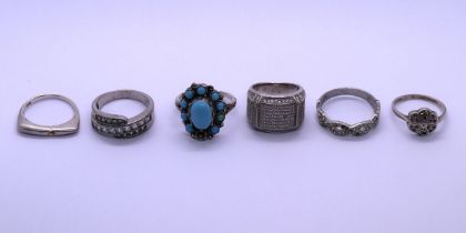 Six silver rings - stones missing