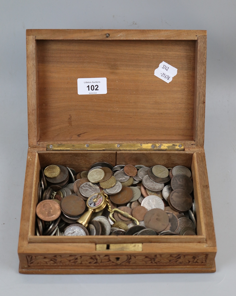 Carved wooden box containing old coins
