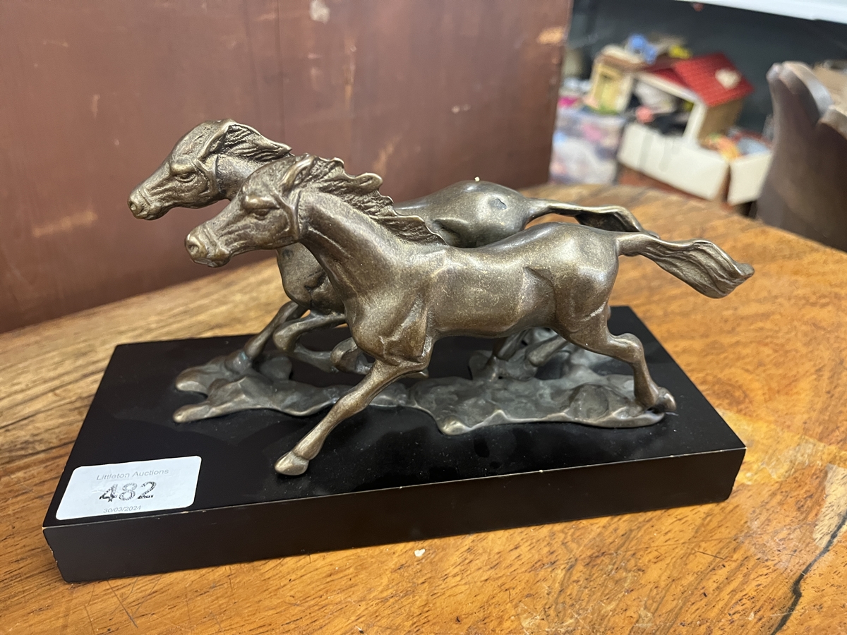 Bronze sculpture of 2 running horses on base
