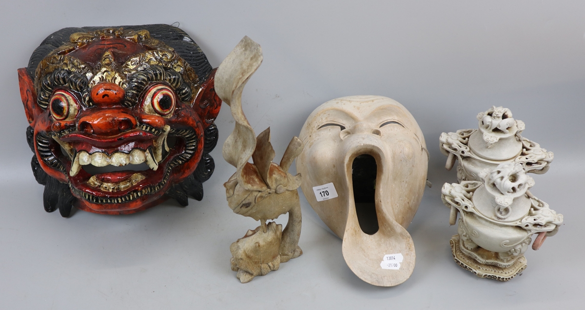 2 face masks together with a sculpture and incense burners