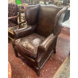 Brown leather wing back armchair