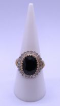 9ct gold ring set with a large sapphire & diamonds - Size M