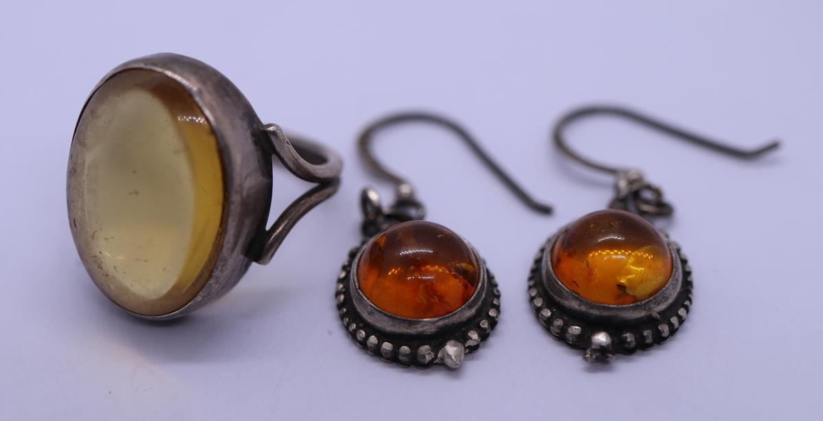 Pair of silver and amber set earrings together with ring