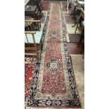 Large red patterned runner - Approx size: 620cm x 78cm