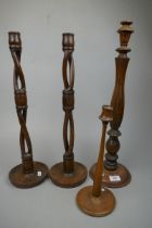 Pair of tall wooden candlesticks together with 2 others
