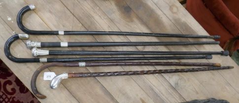 4 ebonized walking canes with hallmarked silver collar, handle and tips together with 2 possibly