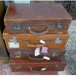 4 leather suitcases some with travel stickers and key