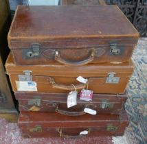 4 leather suitcases some with travel stickers and key