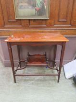 A Victorian mahogany and walnut side table with under tier on square tapering legs Split to top.