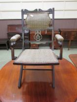 A 20th century stained wood campaign style folding chair