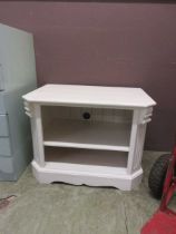 A 20th century white painted TV unit, the top over two shelves