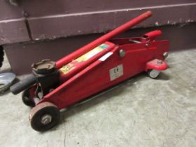 A red metal trolley jack