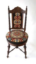 A Victorian beech salon chair, the top rail with poker work style decoration, with turned bobbin