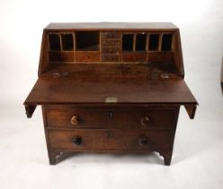 A George III mahogany bureau, the fall front enclosing a fitted interior of drawers and pigeon