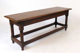 A good reproduction oak bench, with moulded edge on turned supports united by a plain stretcher,