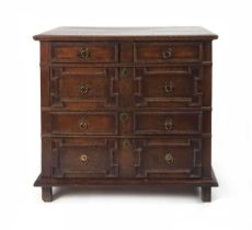 A 17th century oak chest of drawers, the three plank top with applied moulded edge, above a