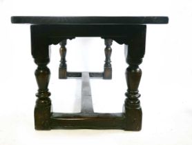 An 18th century and later oak refectory table, the four plank top with cleated ends, on turned