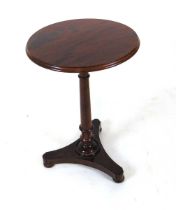 A 19th century mahogany pedestal table, having a well figured circular top, on an inverted