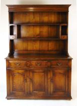 A Titchmarsh & Goodwin oak Welsh dresser, the plate rack with boarded back and two small drawers,