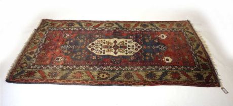 A Turkish red ground village rug, 212cm long x 112cm wide