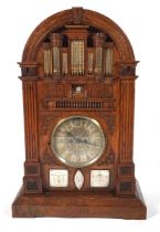 A late 19th century oak 'Church Organ' mantel clock. The top modelled as a pipe organ above reeded