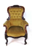 A Victorian upholstered armchair, with carved mahogany show frame, with button back and horsehair