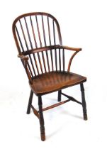 A late 19th century ash and elm Windsor hoop back armchair, the spindle back over a well figured