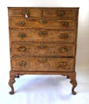 An 18th century walnut chest of drawers, with quarter veneered top above a configuration of two