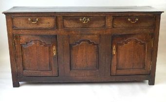 A George III oak Welsh dresser, the plate rack with boarded back and cavetto pediment over applied