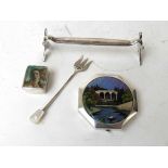 A collection of items to include a WMF silver plated knife rest, a silver pickle fork, silver