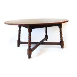 A reproduction oak dining table, having a well figured oval top on a fixed base with bobbin turned