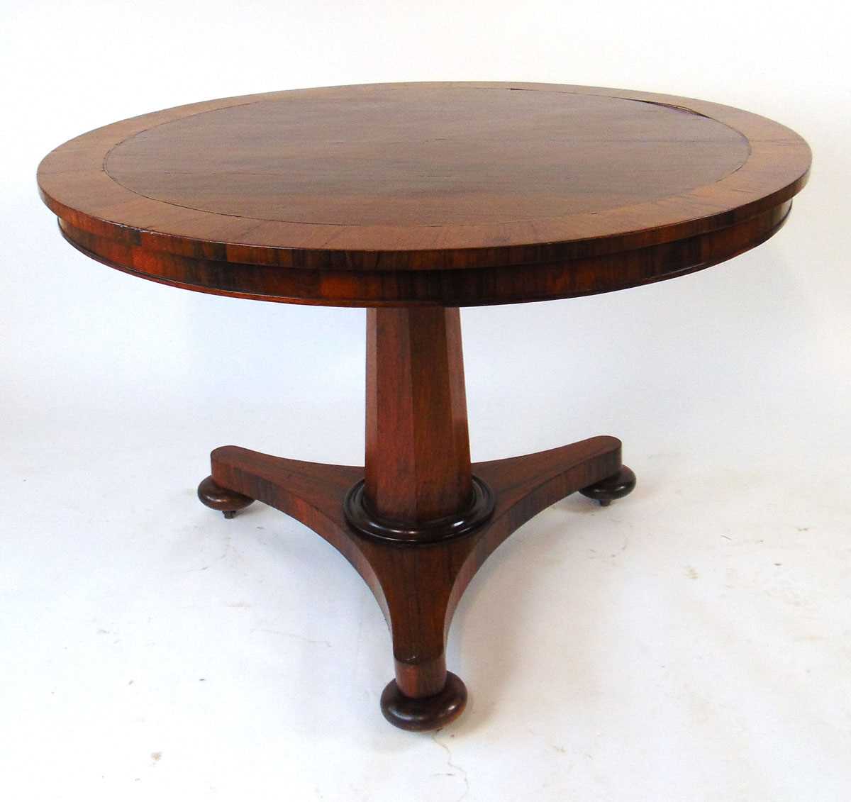 A 19th century rosewood tilt top table, with crossbanded edge and brass stringing, on an octagonal - Image 2 of 4