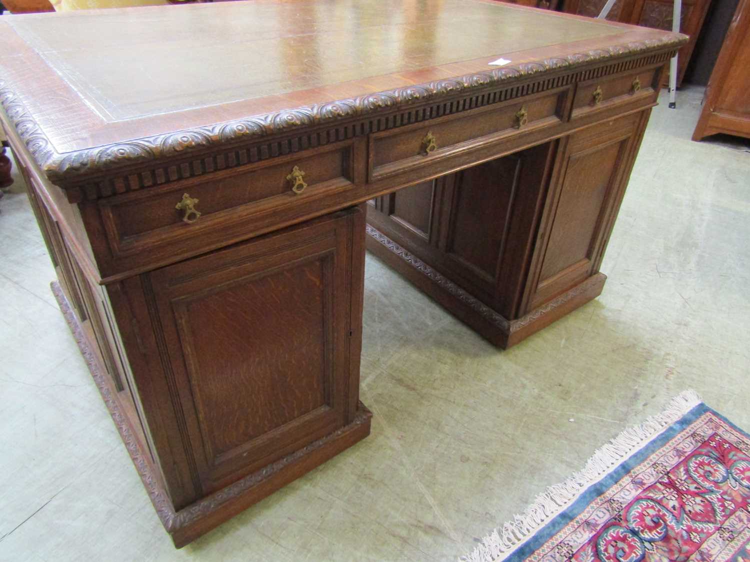 A late Victorian oak partners desk, with green tooled leather writing surface, above a series of - Image 6 of 15